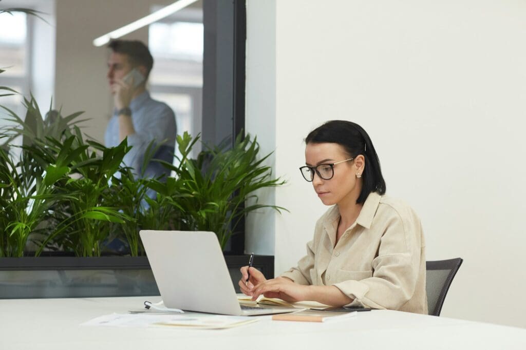 Businesswoman with laptop at office