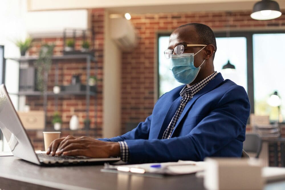 Person looking at laptop screen to plan business project during coronavirus pandemic