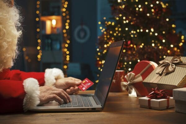 Santa doing online shopping at Christmas